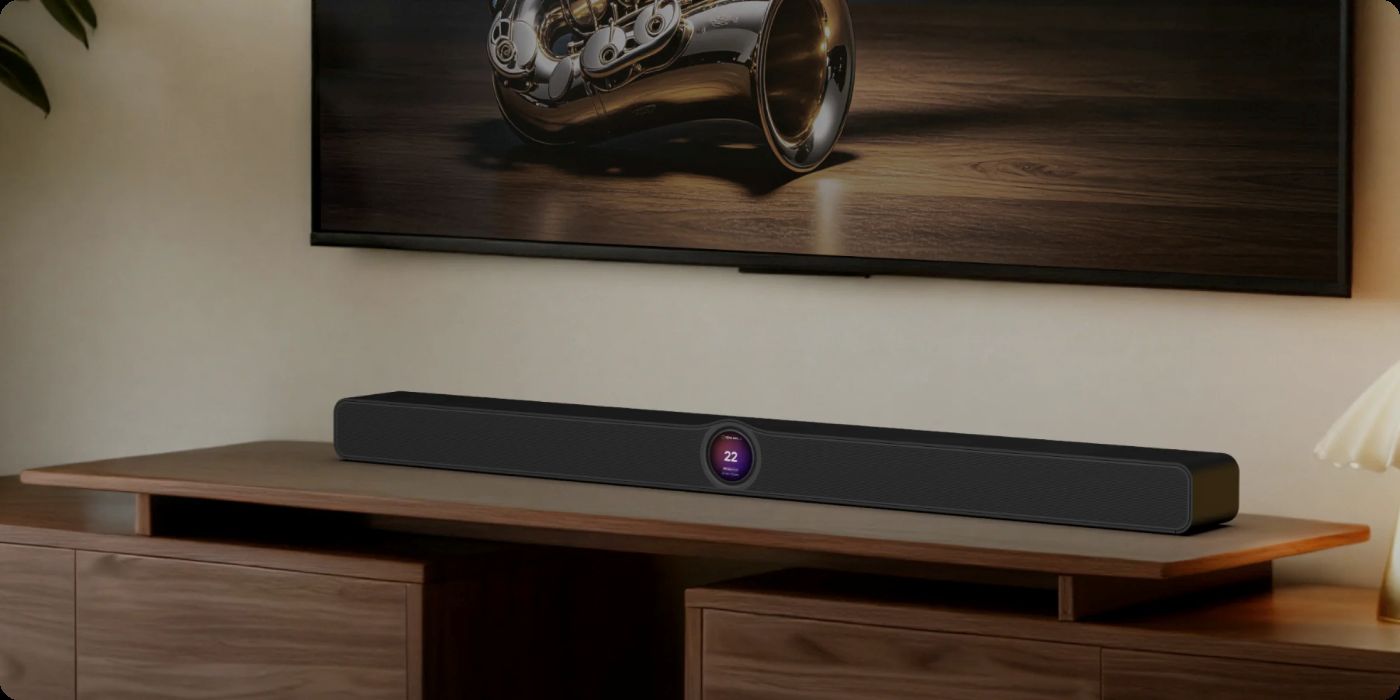 WiiM Bar auf einem TV-Möbel platziert, mit einem TV darüber sichtbar.